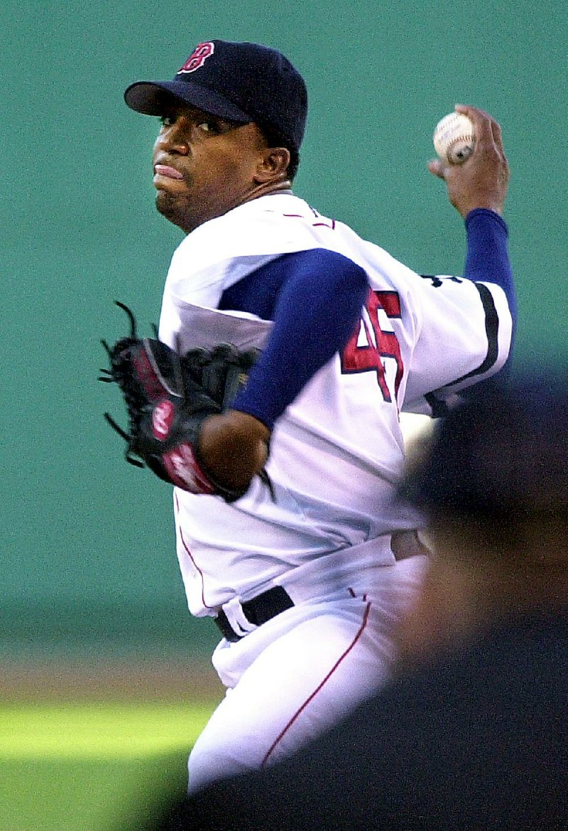 Boston Red Sox starting pitcher Pedro Martinez delivers against the Tampa Bay Devil Rays in the first inning at Boston's Fenway Park, Thursday, July 25, 2002. Home plate umpire Mike Everitt appears right. (AP Photo/Steven Senne)
