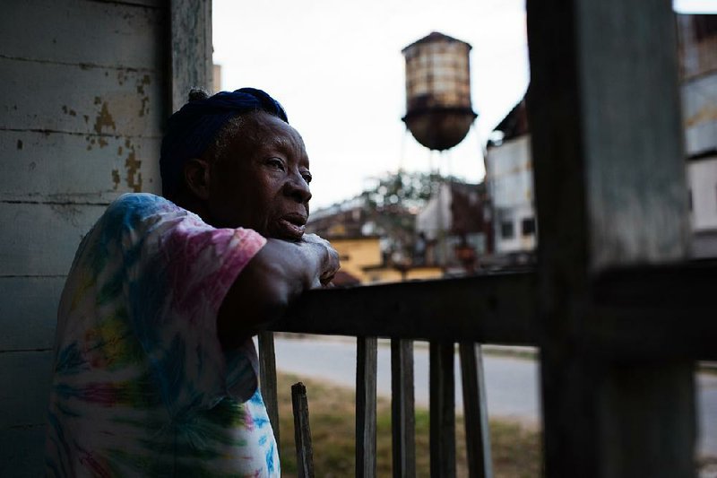 Former sugar mill worker Berta Campoalegre, 81, looks out onto the street from her porch in Hershey, Cuba, where she has lived for about 50 years. Illustrates CUBA-HERSHEY (category i), by Nick Miroff (c) 2015, The Washington Post. Moved Tuesday, May 5,  2015. (MUST CREDIT: Washington Post photo by Sarah L. Voisin)