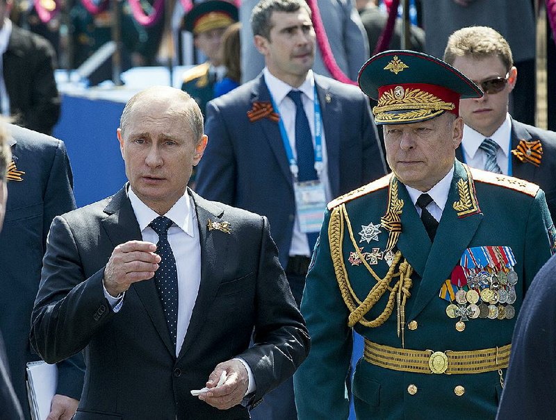 Russian President Vladimir Putin, left, and Commander-in-Chief of the Graund Forces and Victory Parade Commander Colonel-General Oleg Salyukov walk after the Victory Parade marking the 70th anniversary of the defeat of the Nazis in World War II, in Red Square in Moscow, Russia, Saturday, May 9, 2015. (AP Photo/Alexander Zemlianichenko, pool)