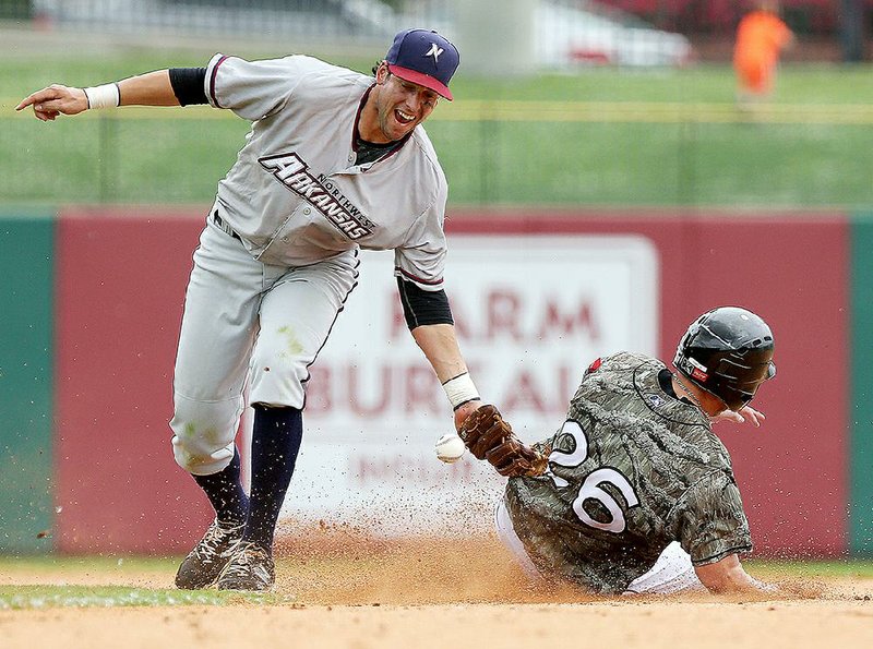 Northwest Arkansas second baseman Alex Liddi can’t handle the throw that allowed Arkansas’ Cal Towey to steal second during the Travelers’ 3-1 loss to Northwest Arkansas in the first game of a doubleheader Sunday at Dickey-Stephens Park in North Little Rock. Northwest Arkansas completed a sweep with an 8-2 victory in the second game.