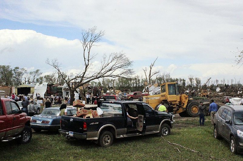 Dozens of people gather to help with cleanup at a farm that was severely damaged by a tornado Sunday in Delmont, S.D. 