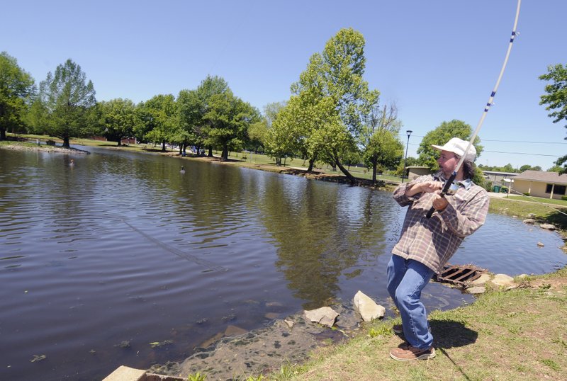 NWA Democrat-Gazette/J.T. WAMPLER Jerry Scott of Springdale tries to set his hook while fishing Monday at Murphy Park&#8217;s pond. City officials have a plan for upgrades at the park, including draining the pond for bank improvements, removing the center island and installing fountains. For photo galleries, go to nwadg.com/photos.