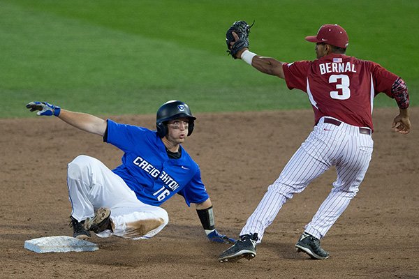 Creighton base runner Kevin Lamb reacts after being tagged out by Arkansas second baseman Michael Bernal during a game Tuesday, May 12, 2015, at TD Ameritrade Park in Omaha, Neb. (Mark Davis/Omaha World-Herald)