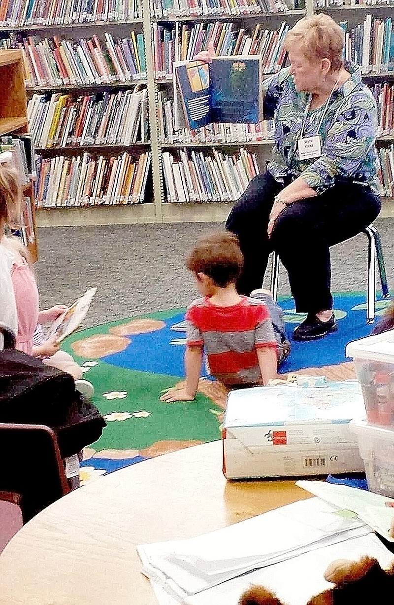 Submitted Miss Myra reads all about frogs at Preschool Storytime.