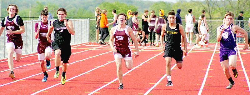 STAFF PHOTO RANDY MOLL Prairie Grove&#8217;s Anthony Johnson (second from right) sprints during the 4A Conference track and field meet.