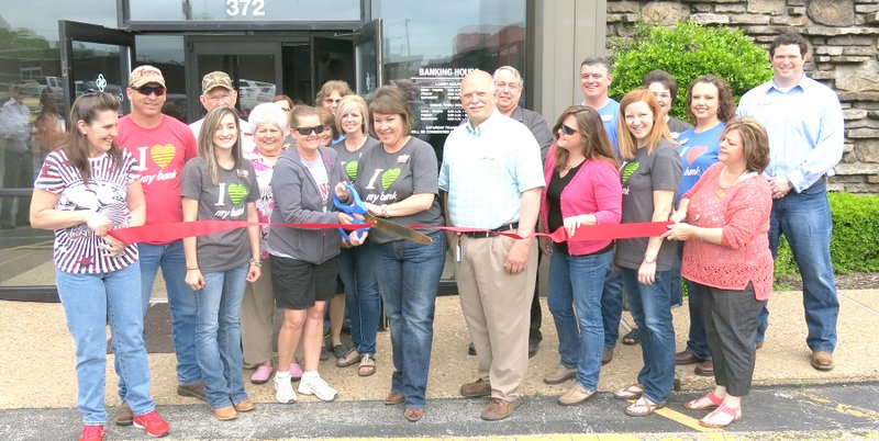 Photo by Mike Eckels Dignitaries and honored guests gathered together as Margo Barnes, center, left, from the Decatur Chamber of Commerce and Carla Martinez, branch president, center, right, cut the ribbon, formally opening the Grand Savings Bank branch in Decatur May 8.