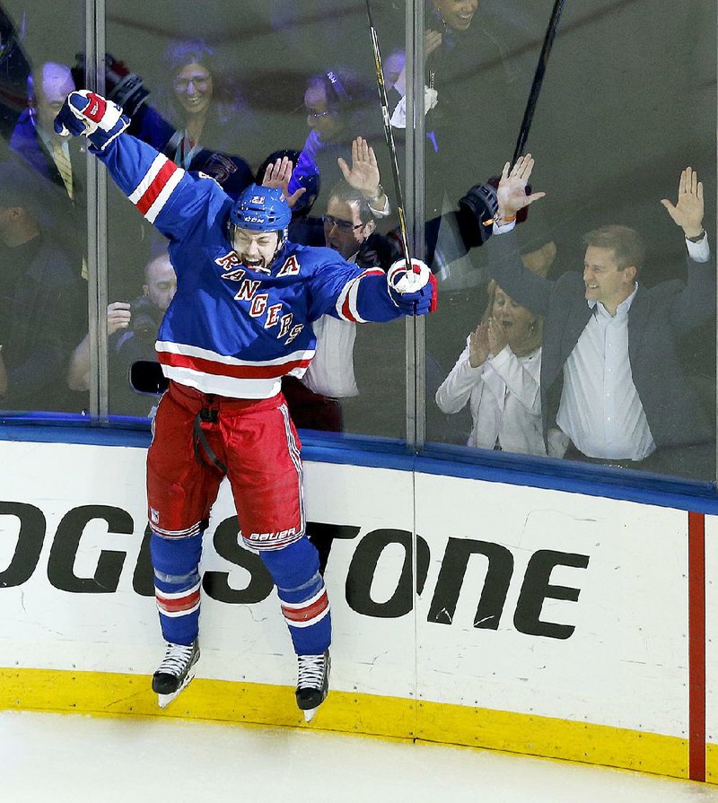 New York Rangers Derek Stepan celebrates with teammates after scoring the  game winning goal in overtime against the Washington Capitals in game 7 in  the second round of the Stanley Cup Playoffs