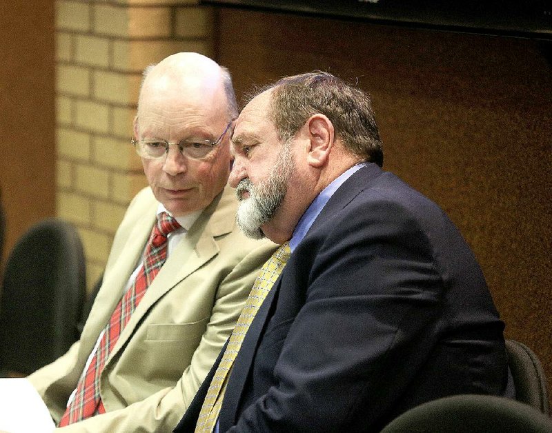 Little Rock School District Superintendent Baker Kurrus (left) talks Wednesday with Pulaski County Special School District Superintendent Jerry Guess at a meeting on boundaries for the three school districts in the county. 