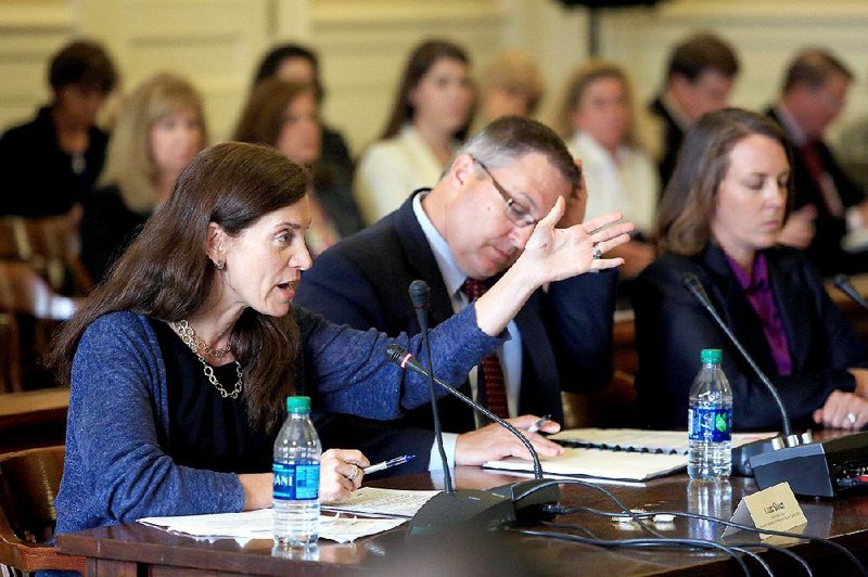 Laura Slover of Partnership for Assessment of Readiness for College and Careers and ACT official Scott Montgomery appear before the state review committee Wednesday at the Capitol. 