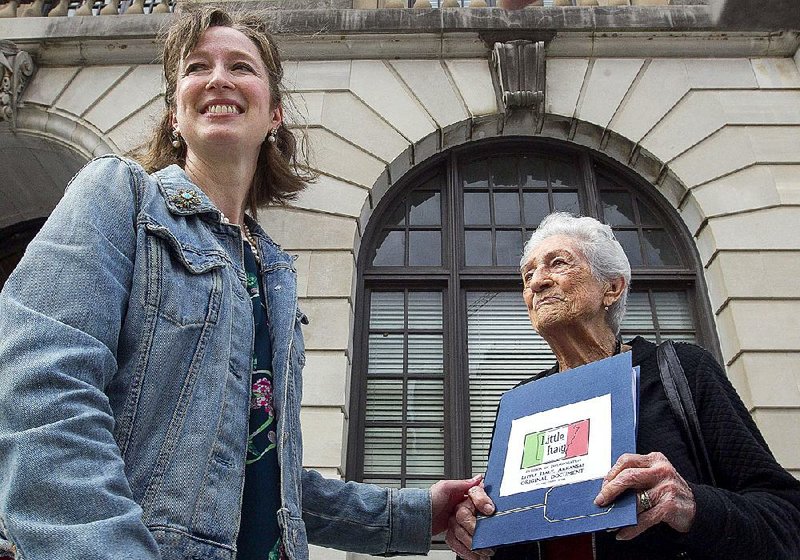 Kristy Eanes (left) and Olga Dal Santo deliver a folder with signatures to the Pulaski County Courthouse on Wednesday to file a petition for the incorporation of the Little Italy community in Pulaski County. 