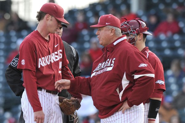 Starter Trey Killian of Arkansas speaks with pitching coach Dave Jorn against Mississippi during the second inning Friday, March 27, 2015, at Baum Stadium in Fayetteville.