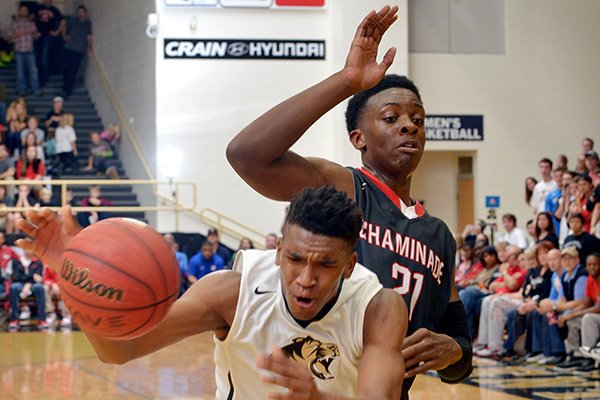 Malik Monk of Bentonville drives against Tyler Cook of St. Louis Chaminade during the game in Bentonville's Tiger Arena on Saturday Nov. 29, 2014.