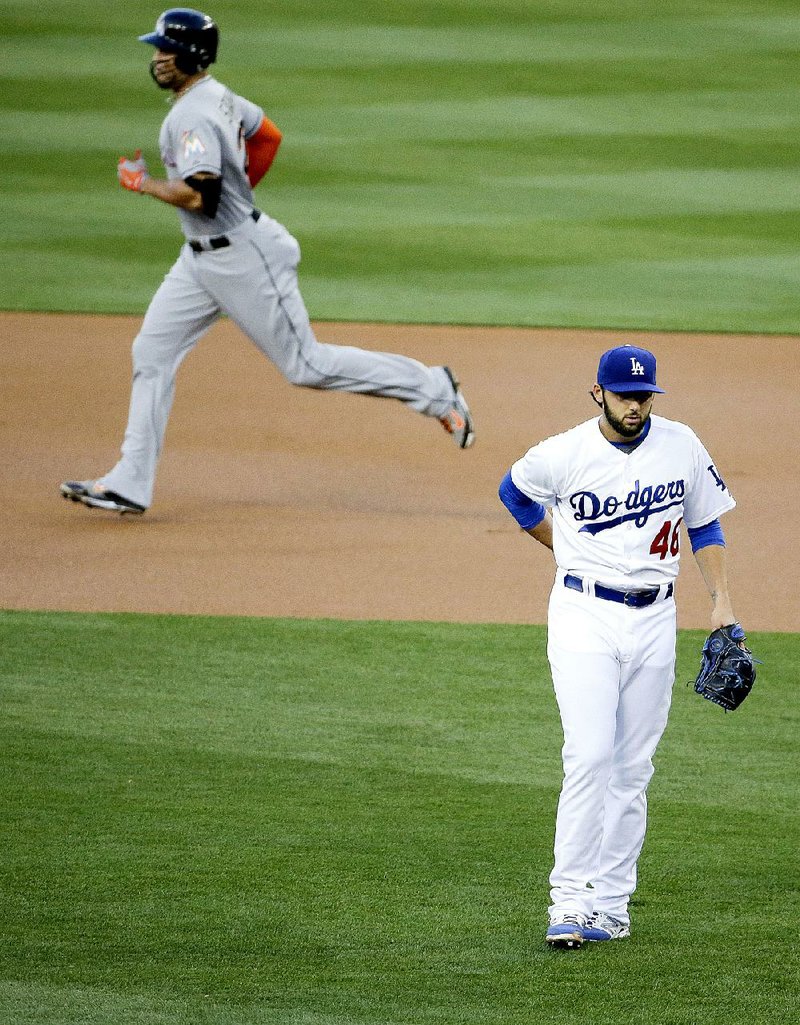 Los Angeles Dodgers pitcher Mike Bolsinger (bottom right) allowed the longest home run in major-league baseball this season to Miami’s Giancarlo Stanton on Tuesday, but Bolsinger and the Dodgers got the last laugh with an 11-1 victory. 