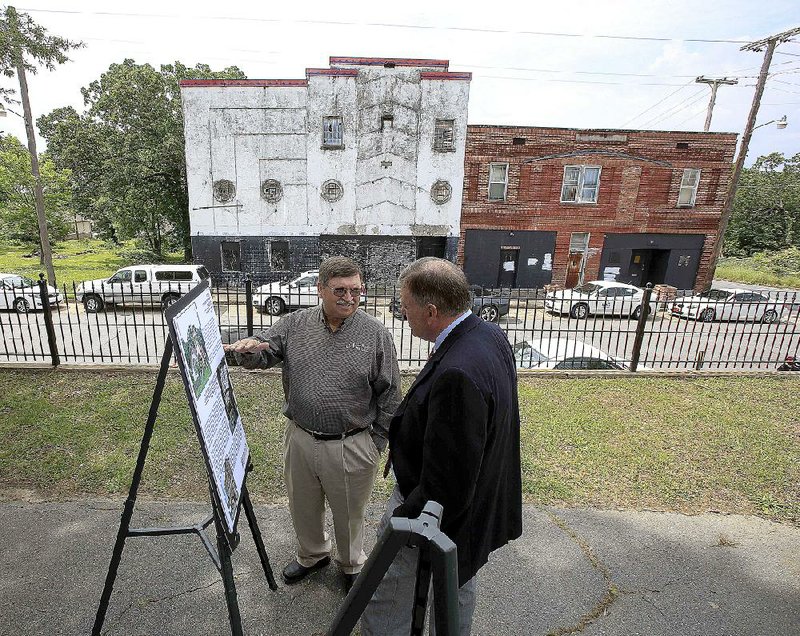 Arkansas Tech history professor Tom DeBlack (right) talks with Howard County Historical Society Chairman Freddie Horne on Thursday in front of the Lee Theater at 3819 W. 13th St. in Little Rock after it was announced that the Historic Preservation Alliance of 2015 had added the theater to the list of Arkansas’ Most Endangered Historic Places. 