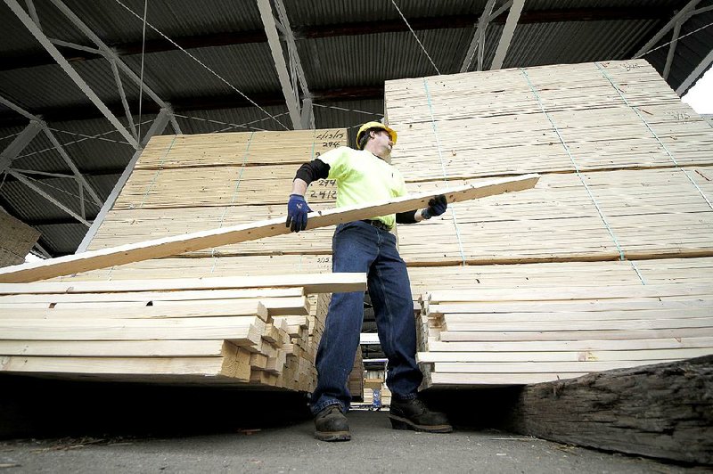 Chuck Barrett helps a customer load lumber at the Allegheny Millwork and Lumberyard in Pittsburgh in March. A 0.4 percent drop in the producer price index in April followed a 0.2 percent gain in March, the Labor Department said Thursday. 