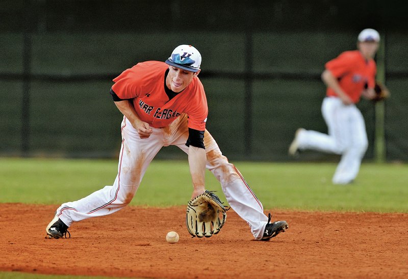 NWA Democrat-Gazette/BEN GOFF Chase Kilgore fields a ground ball Thursday while playing shortstop for Rogers Heritage during the first-round game against Bryant in the 7A State Baseball Championships at Bentonville&#8217;s Tiger Athletic Complex.