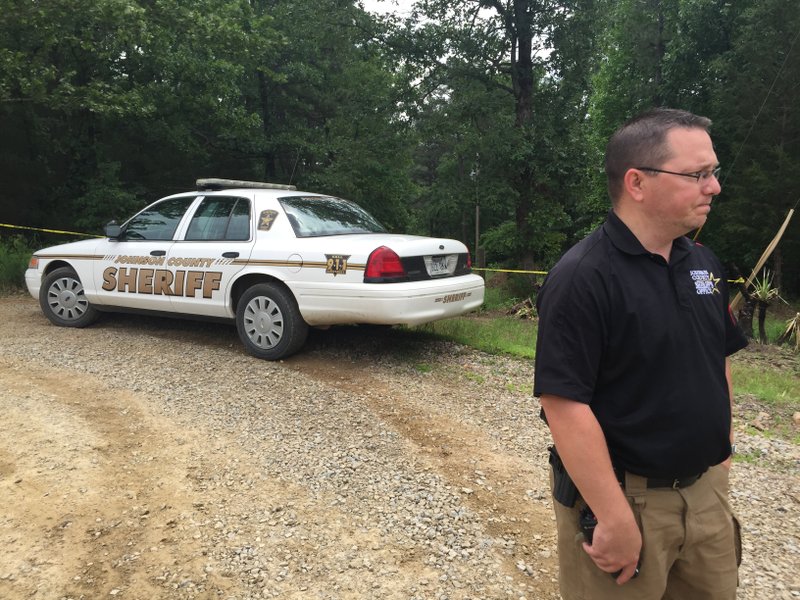 Johnson County Deputy Tristan Teague at the driveway of the scene on County Road 1723.