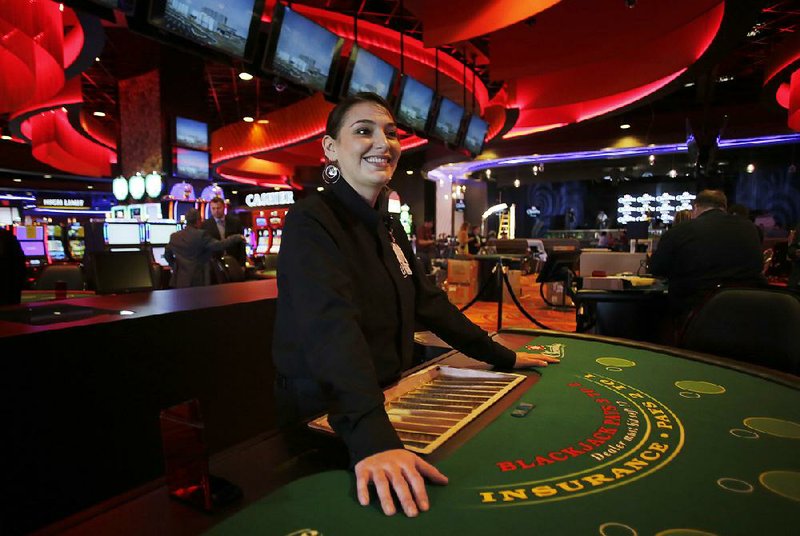 Charlee Honeycutt, a dealer at one of the blackjack tables inside Cherokee Casino & Hotel in Roland, Okla., participates in a dress rehearsal.