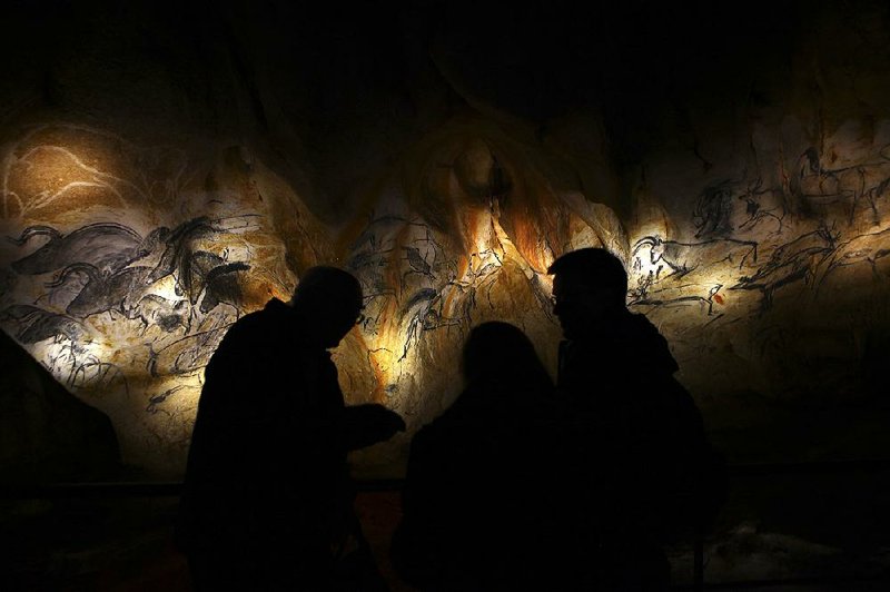 Visitors scrutinize reproduced drawings inside a replica of the Chauvet cave, built for $59 million near Vallon Pont d’Arc in the Ardeche region of south-central France. The nearby cave, discovered 20 years ago, is renowned for its prehistoric paintings. 