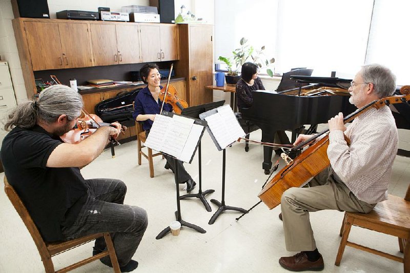 Paulo Eskitch, viola; Er-Gene Kahng, violin; Tomoko Kashiwagi, piano; and Stephen Gates, cello, rehearse for a trio of chamber music concerts in Fayetteville and Bentonville.