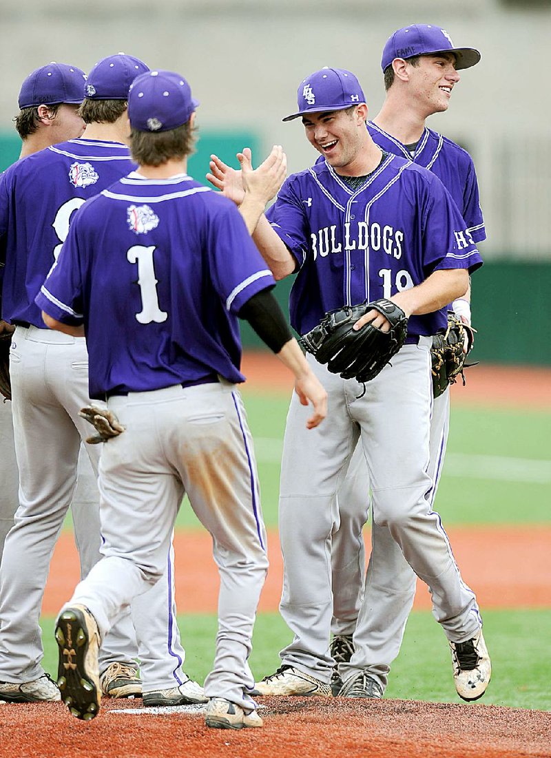 Fayetteville pitcher Andy Pagnozzi (19) is congratulated by his teammates after pitching a perfect game to lead the Bulldogs to a 10-0, run-ruled victory over Little Rock Central in the second round of the Class 7A baseball state tournament at Bulldog Field in Fayetteville. 