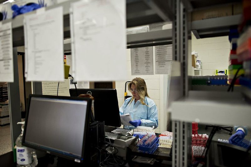 Lacey Kurth, a research associate, works with avian influenza test samples earlier this month at Iowa State University in Ames. The top U.S. egg producer, Iowa has been the state hit hardest by avian flu, losing 40 percent of its laying hens. 