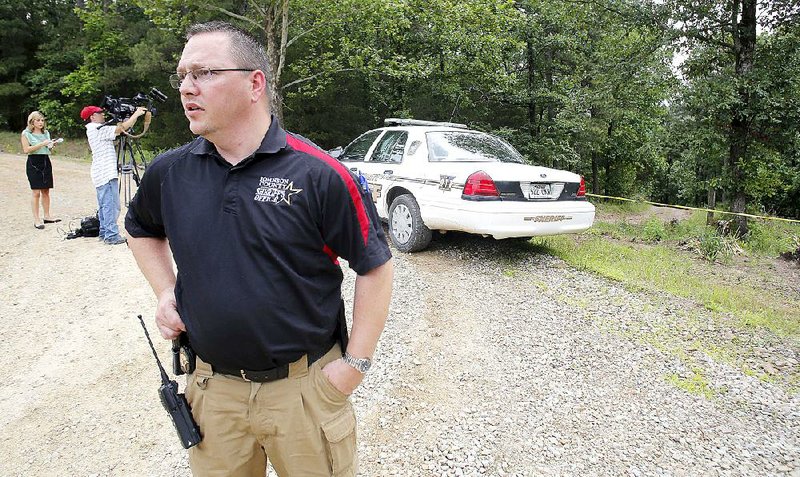 Tristan Teague, a deputy with the Johnson County sheriff’s office, stands at the driveway on Johnson County Road 1723, scene of the investigation of the fatal shooting of reserve Deputy Sonny Smith of Clarksville. 