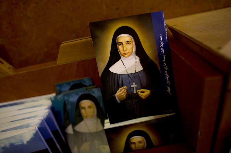 In this Thursday, May 7, 2015 photo, booklets showing the likes of Marie Alphonsine Ghattas, a nun who lived in what was Ottoman-ruled Palestine in the 19th century, are on display in Church of the Rosary Sisters Mamilla in Jerusalem. The Holy Land's Christians are excitedly preparing for next week's canonization of two Arab nuns, Ghattas and Mariam Bawardy, bringing some joy to a tiny community that has had little to celebrate in recent years.