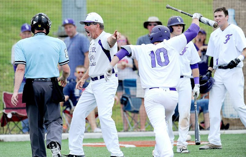 Fayetteville Coach Vance Arnold (center) argues with the home plate umpire after Cody Davenport (10) struck out on a game-ending check swing in a 3-2 semifi nal loss to Conway in the Class 7A baseball state tournament Saturday. Conway, which lost to Fayetteville 3-2 earlier in the season, will play Bentonville on Friday for the championship.