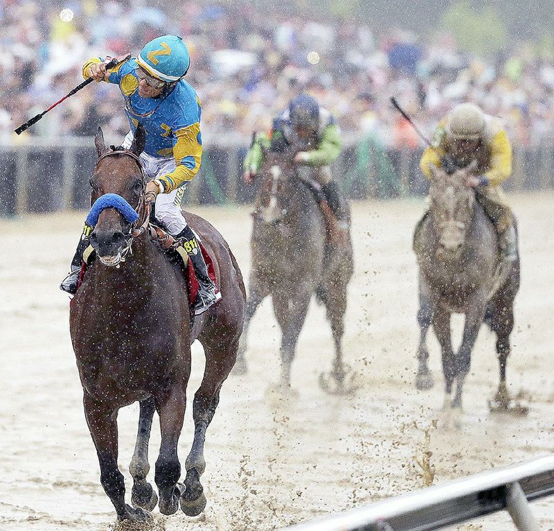 American Pharoah (front), ridden by Victor Espinoza, kept Triple Crown hopes alive by rolling to a 7-length victory at the 140th Preakness Stakes on Saturday in front of a record crowd of 131,680 at Pimlico Race Course in Baltimore.