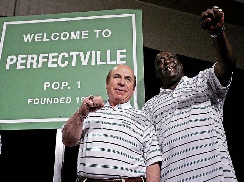 In this Feb. 1, 2008., file photo, former Miami Dolphins players Garo Yepremian, left, and Larry Little talk about their 1972 team's perfect season at a news conference in Phoenix. Yepremian, the former NFL kicker who helped the  Dolphins win consecutive NFL championships but is best remembered for a Super Bowl blooper, died Friday, May 15, 2015, of cancer. 