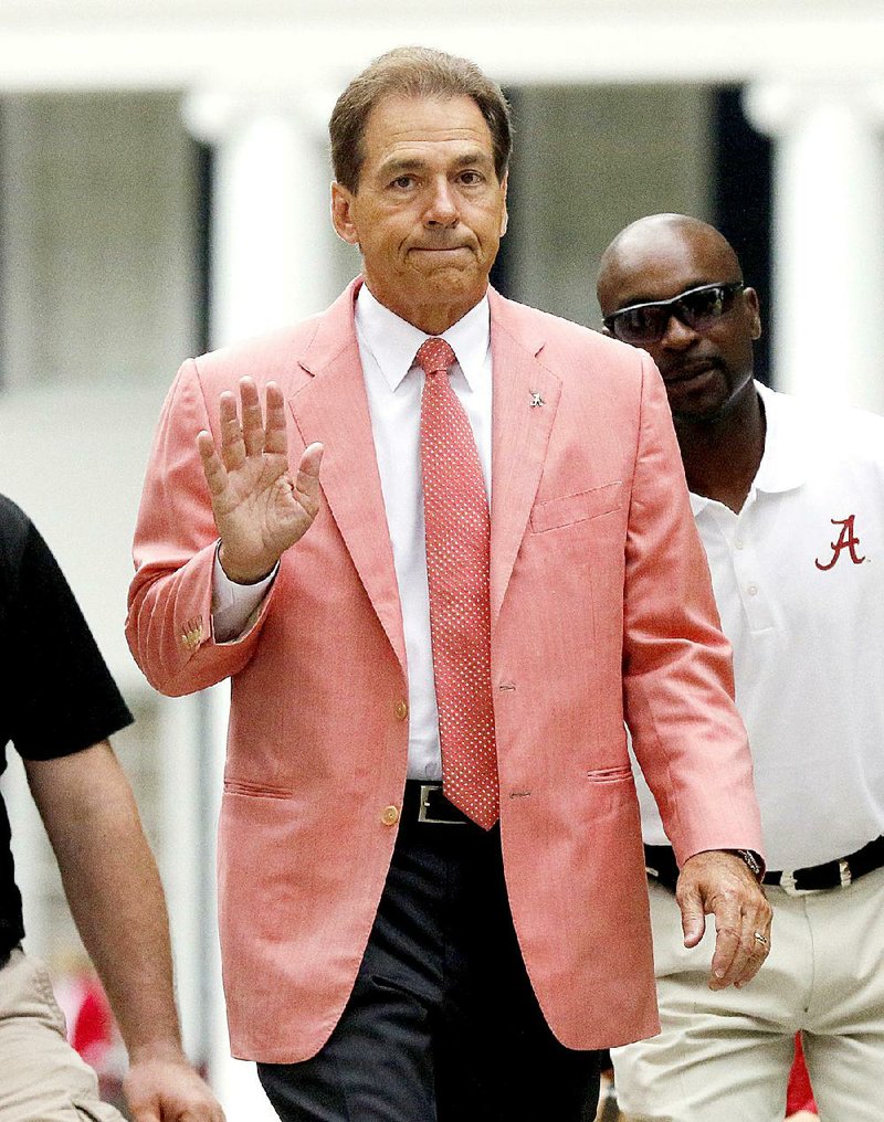 Alabama head coach Nick Saban waves to fans during a ceremony for former captains before Alabama's spring NCAA college football game, Saturday, April 18, 2015, in Tuscaloosa, Ala. 