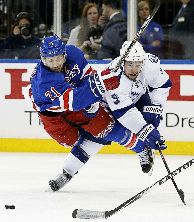 New York Rangers center Derek Stepan (21) gets tangled up with Tampa Bay Lightning center Tyler Johnson (9) Saturday during the second period of Game 1 of their NHL playoff series. The Rangers held on for a 2-1 victory.