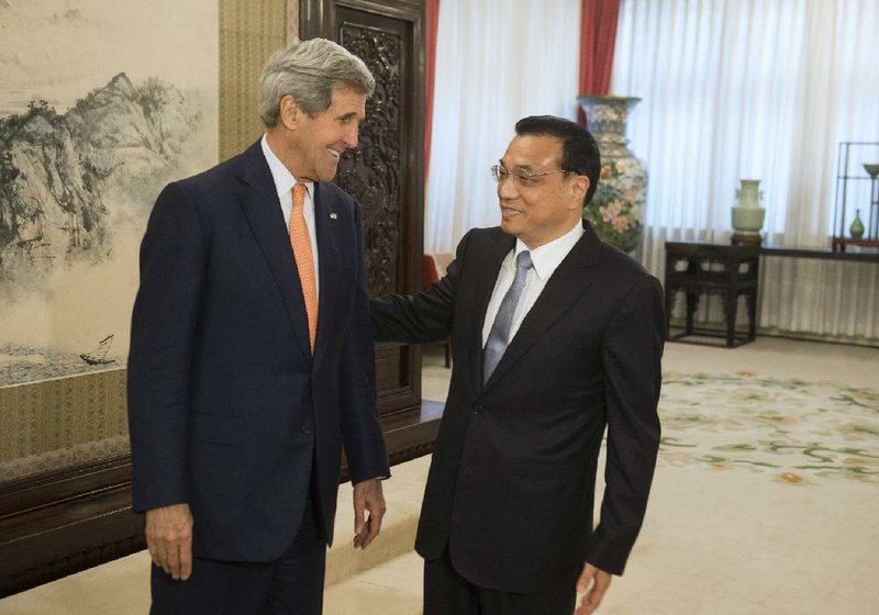 U.S. Secretary of State John Kerry talks Saturday with Chinese Premier Li Keqiang in Beijing. Kerry stressed the need for diplomacy amid tension over China’s land reclamation in the South China Sea.