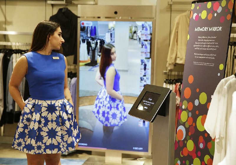 Christie McAllister, visiting from San Francisco, prepares to use a fitting room equipped with eBay’s touch screen fitting room technology, at Rebecca Minkoff in New York in April. The interactive technology provides a virtual assistant inside fitting rooms for shoppers, displaying their selections and a catalog to modify choices and accessorize.