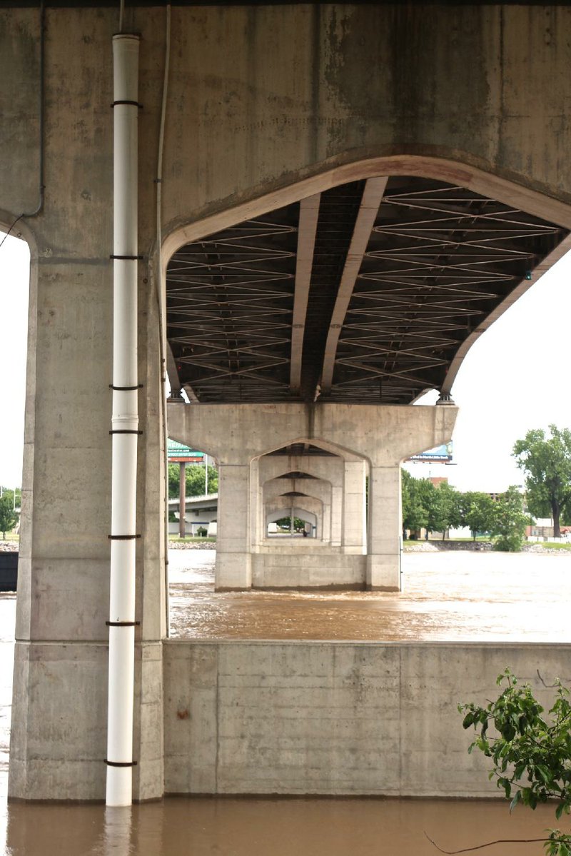 Part of the Little Rock river gauge device is inside a white PVC tube attached to a pier on the Main Street Bridge. The gauge relays the Arkansas River’s water level data via satellite to the U.S. Geological Survey.