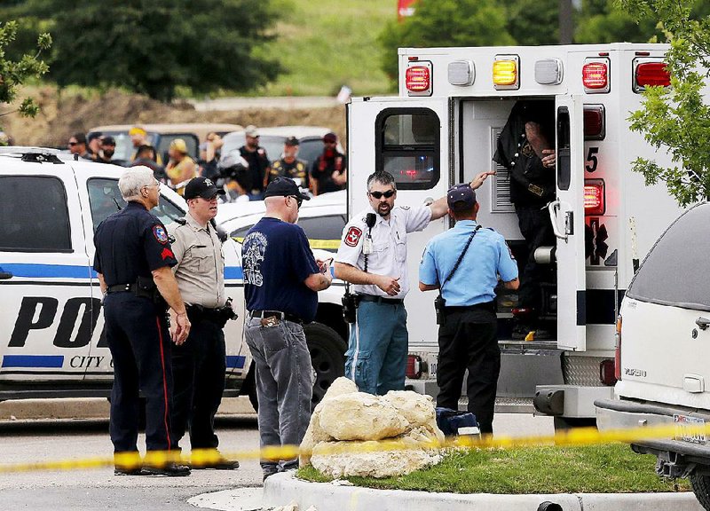 Emergency responders tend to a wounded person Sunday near a Twin Peaks restaurant in Waco, Texas. 