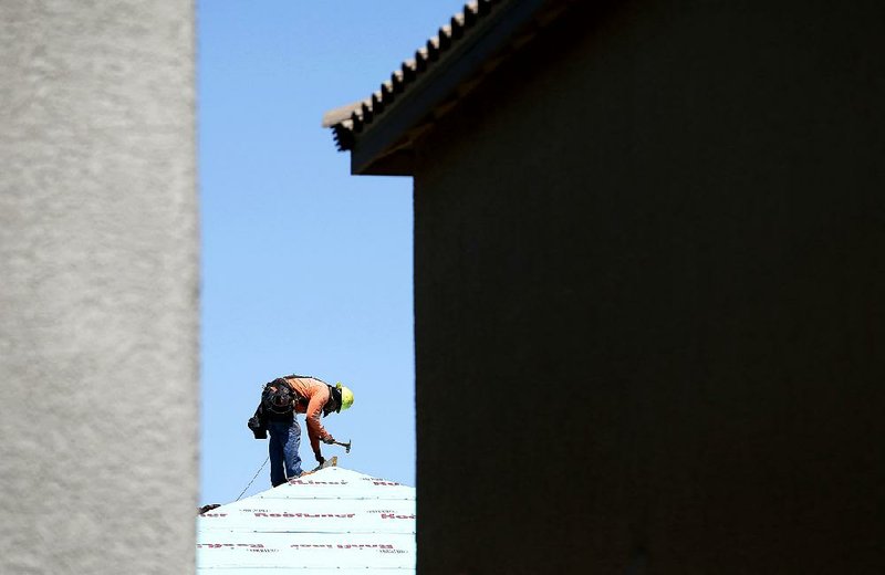 A worker frames a home at a housing development in Las Vegas last month. 