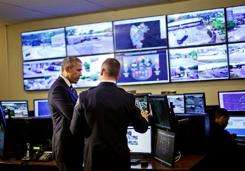 President Barack Obama is briefed Monday by Police Chief J. Scott Thomson during a visit in Camden, N.J., to the Police Department’s Real Time Tactical Operational Intelligence Center. 