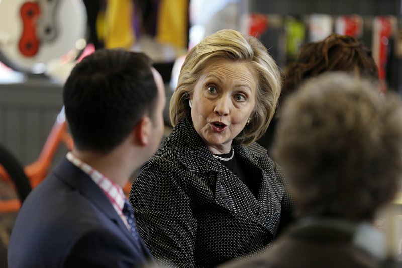 Democratic presidential candidate Hillary Rodham Clinton talks to Brad Magg, left, owner of Goldie’s Ice Cream Shoppe and Magg Family Catering, during a meeting with small business owners, Tuesday, May 19, 2015, at the Bike Tech cycling shop in Cedar Falls, Iowa. 