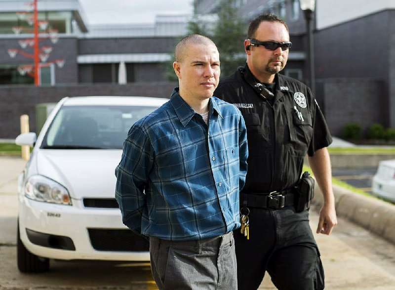 Zachary Holly is escorted into the Benton County Courthouse in Bentonville on Tuesday, May 19, 2015, for his trial in the murder of 6-year-old Jersey Bridgeman.