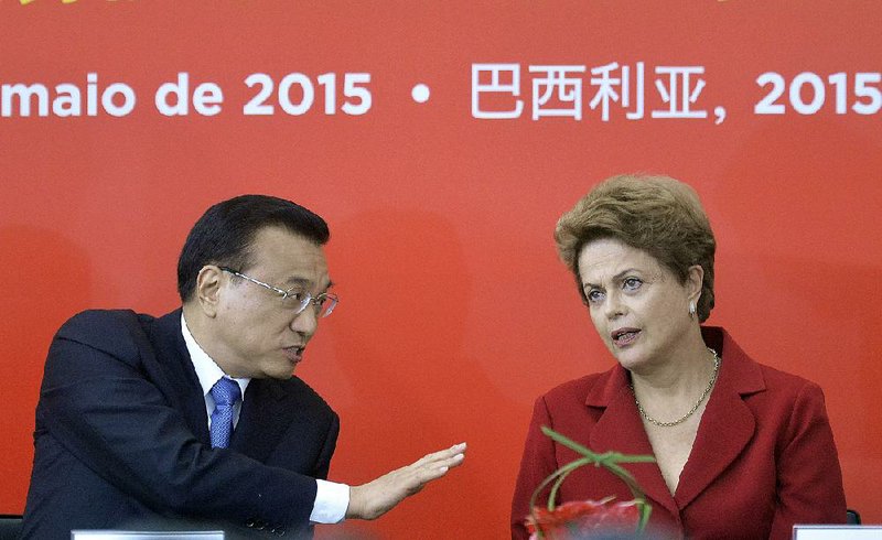 China’s Premier Li Keqiang and Brazil’s President Dilma Rousseff attend a signing ceremony Tuesday at the Planalto presidential palace in Brasilia, Brazil. 