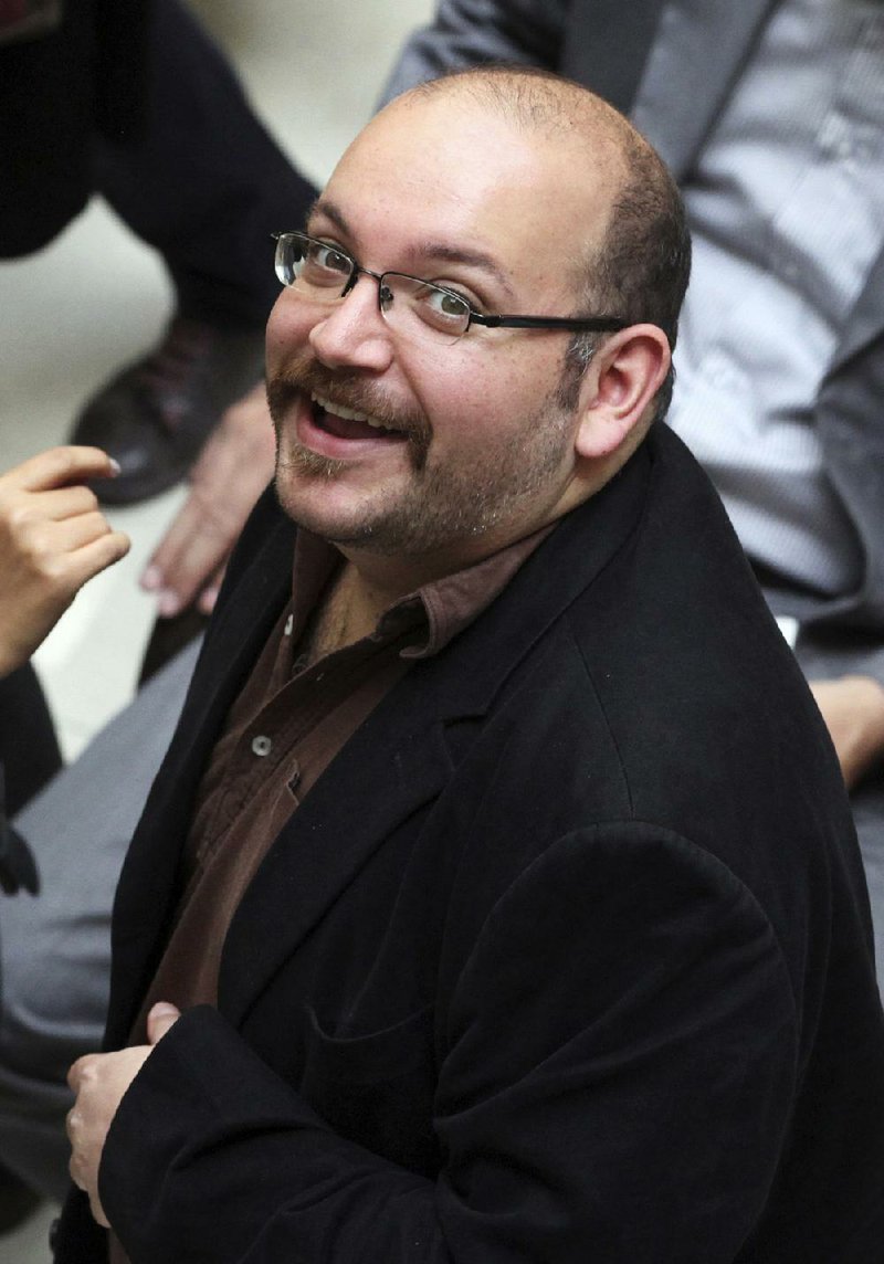 In this April 11, 2013 file photo, Jason Rezaian, an Iranian-American correspondent for the Washington Post smiles as he attends a presidential campaign of President Hassan Rouhani in Tehran, Iran.  