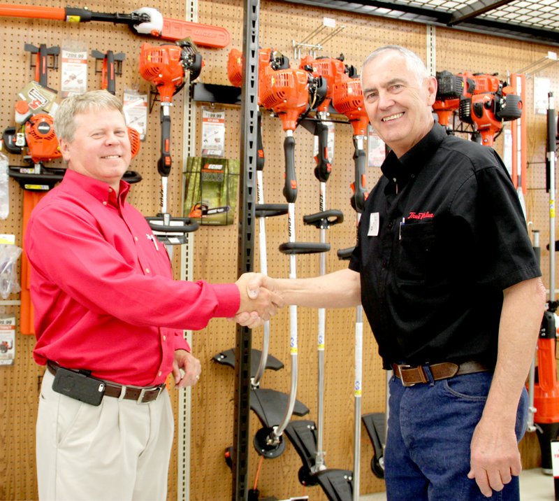 LYNN KUTTER ENTERPRISE-LEADER Mark O&#8217;Neal, retail consultant with True Value, left, helped during the grand open for the Farmers Co-Op True Value store in Lincoln. Richard Cooper is manager of the store. The store now carries Echo power equipment, seen in the background behind the two men.