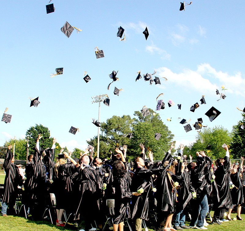 LYNN KUTTER ENTERPRISE-LEADER Graduation is complete as Prairie Grove High School&#8217;s 116 graduates throw their caps in the air to celebrate Saturday afternoon at Tiger Den football stadium. While temperatures were hot, skies remained sunny for the large crowd that attended the 2015 Prairie Grove commencement. See more photos from graduation on Page 8A.