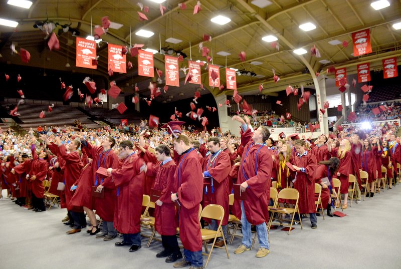 Janelle Jessen/Herald-Leader Students threw their mortarboards in the air in celebration after the commencement on May 16 in Barnhill Arena.