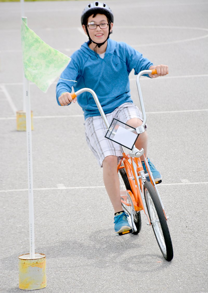 Janelle Jessen/Herald-Leader Alex Arriaga zipped in and out of a bicycle obstacle course during the Intermediate School bicycle rodeo.