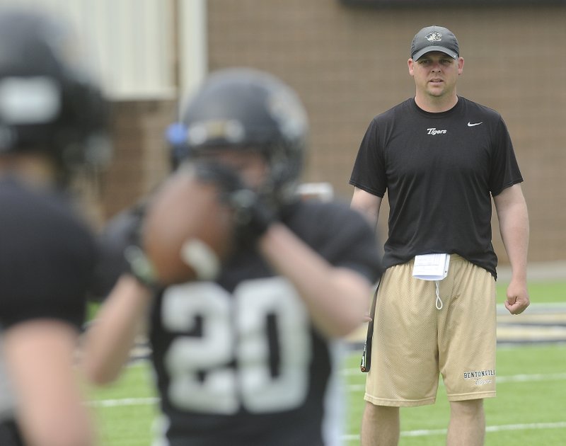 Jody Grant, Bentonville’s first year head coach, conducts practice Monday at Bentonville.