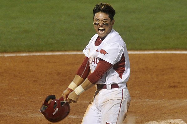 Arkansas' Rick Nomura celebrates after scoring the game-winning run in the ninth inning of an SEC Tournament game against Tennessee on Tuesday, May 19, 2015, at Hoover Metropolitan Stadium in Hoover, Ala.