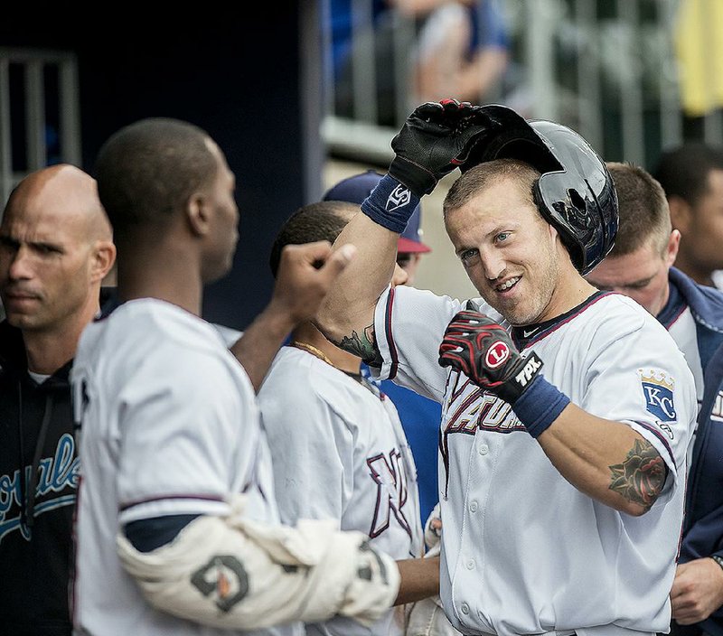 Northwest Arkansas Naturals designated hitter Mike Bianucci (right) is congratulated after hitting a home run Wednesday.